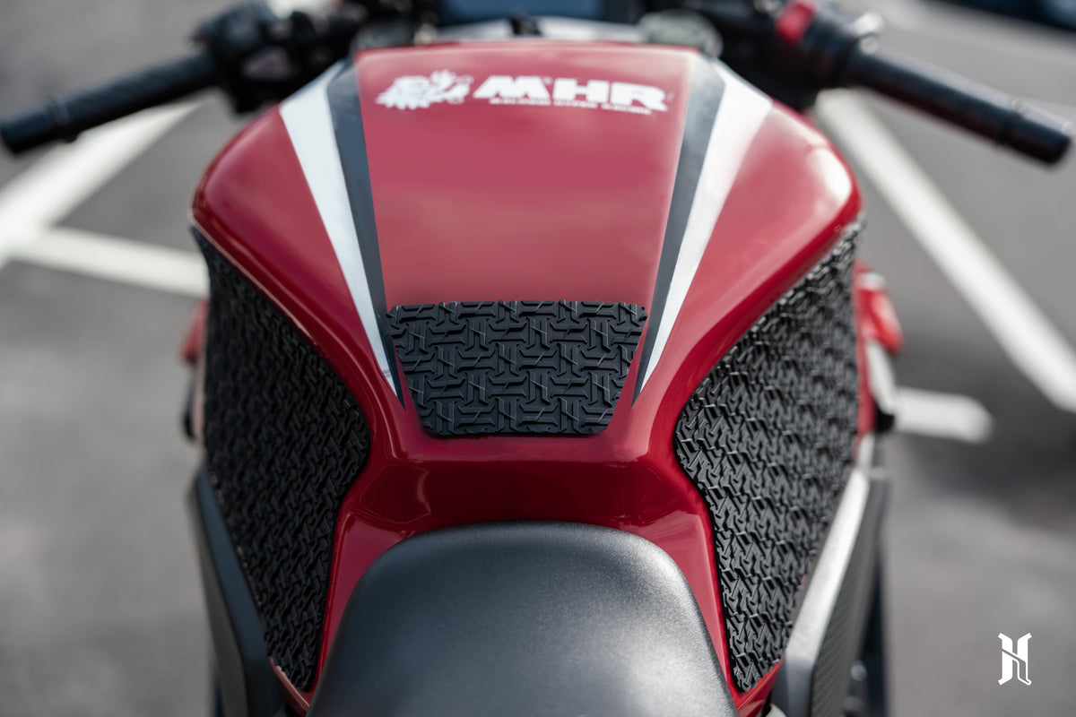 rider knee grip contact with Honda CBR650R tank pads showing improved riding control and body positioning