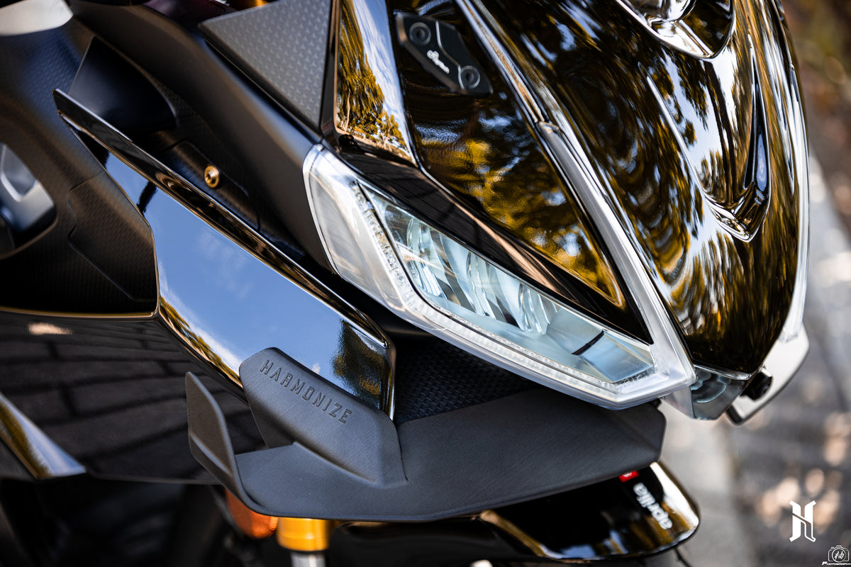 Detailed view of HARMONIZE MotoTech winglet installation on Aprilia RS660 front fairing