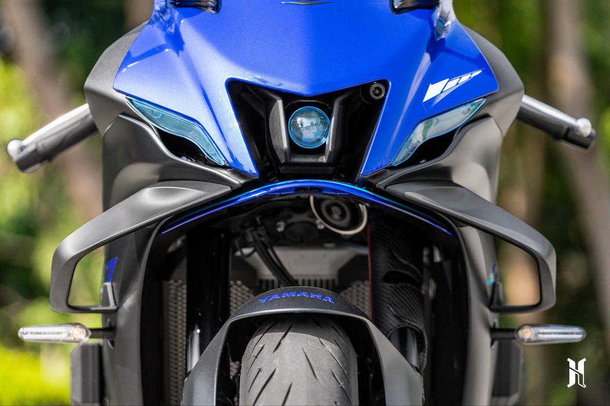 Front fairing close-up showing HARMONIZE MotoTech aerodynamic winglets installation on Yamaha YZF-R7, designed for improved downforce and stability